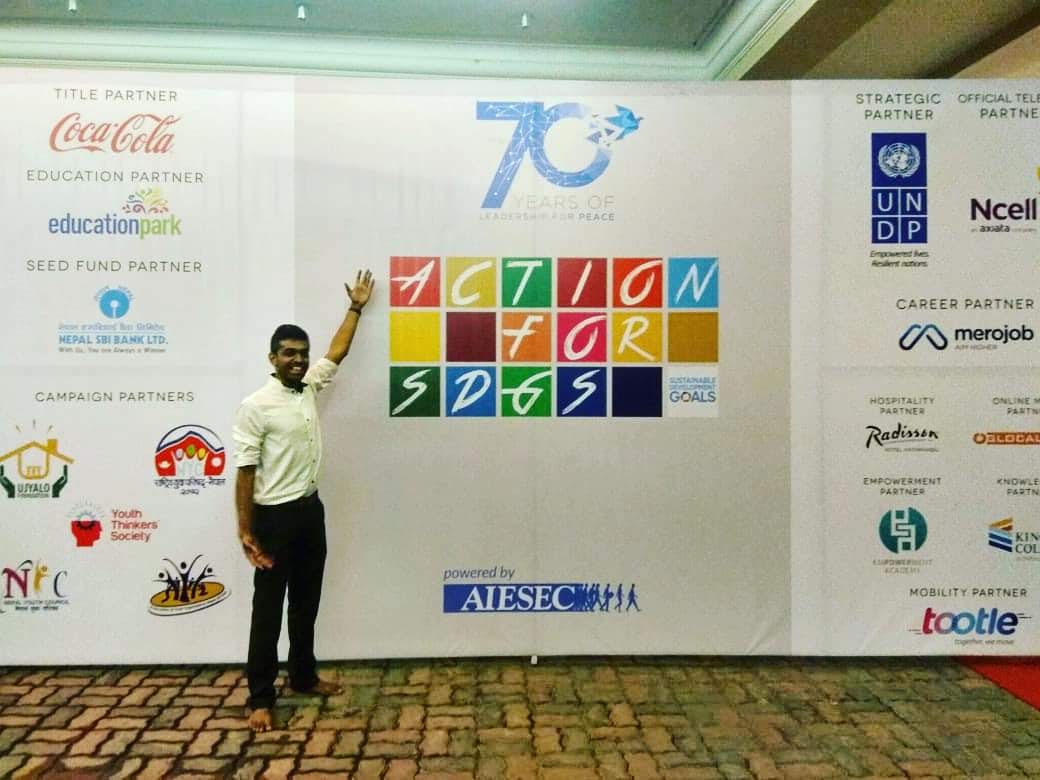 Narayanan at the AIESEC Action for SDGs summit backdrop in Kathmandu